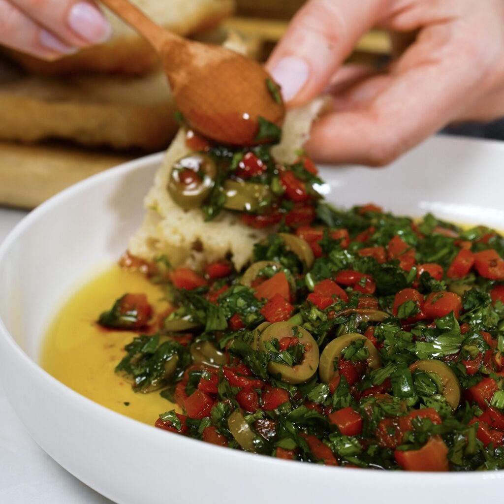 Roasted red pepper olive dip served with freshly baked homemade bread