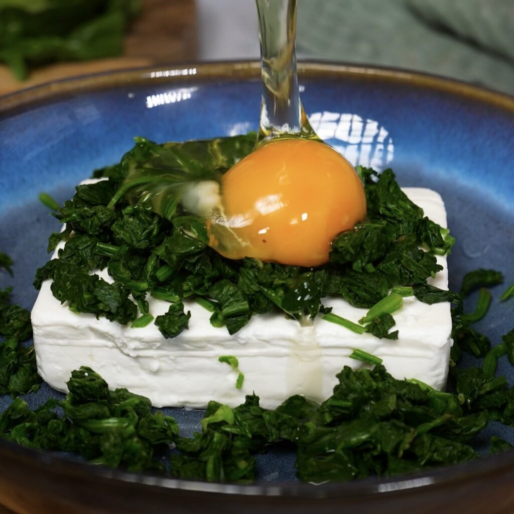 Spinach and feta filling ingredients in a bowl before mixing for puff pastry rolls