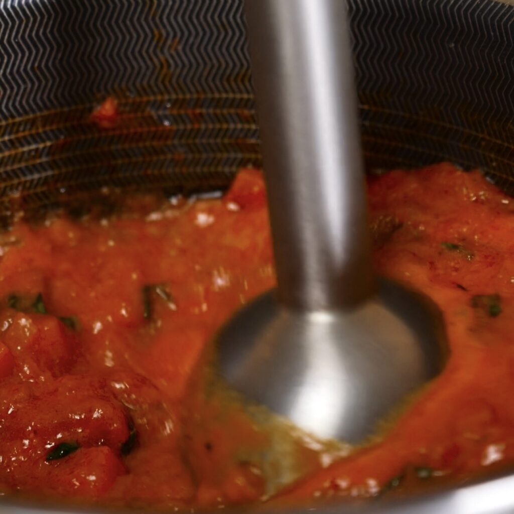 Blending the tomato sauce until smooth for stuffed Caccavelle pasta bake