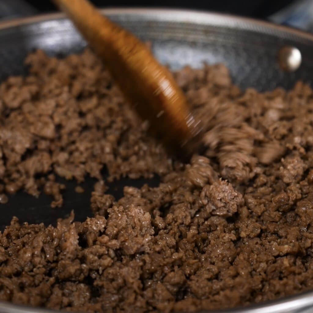 Cooking minced beef with seasoning for stuffed Caccavelle pasta bake