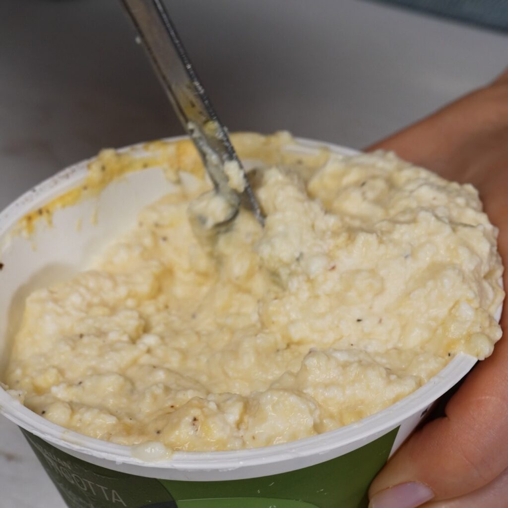 Mixing ricotta filling for stuffed Caccavelle pasta bake