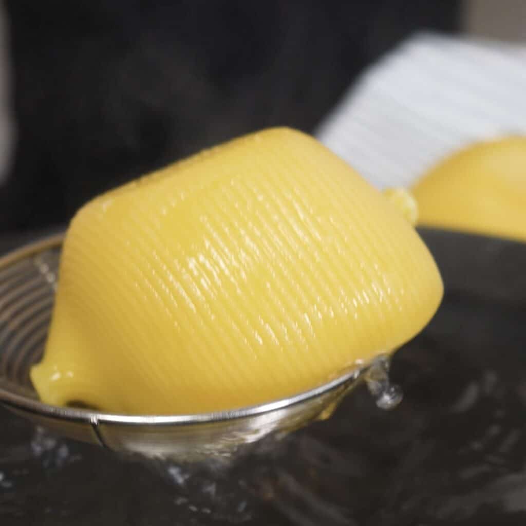 Lifting cooked Caccavelle pasta shells from boiling water