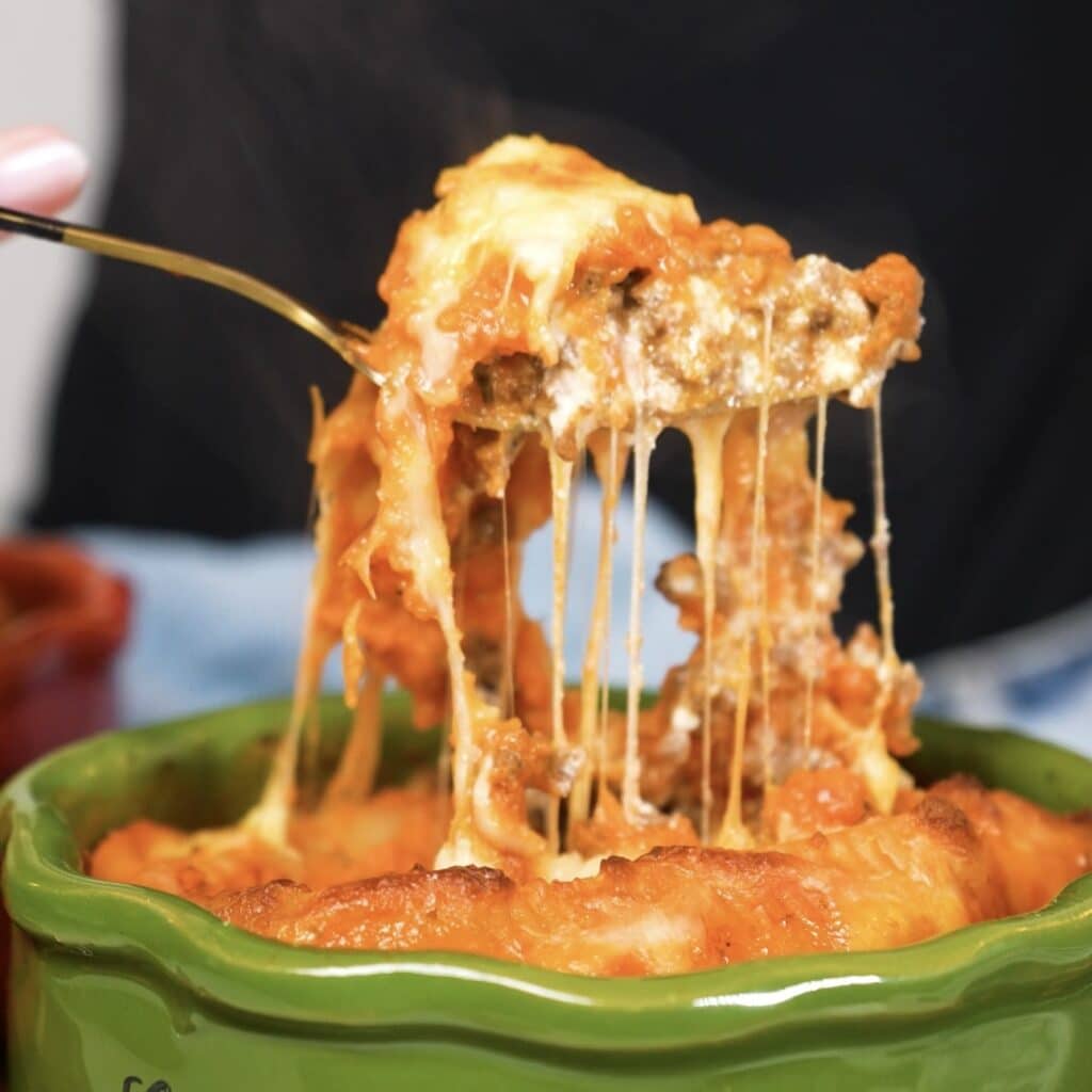 Freshly baked stuffed Caccavelle pasta with melted cheese pull