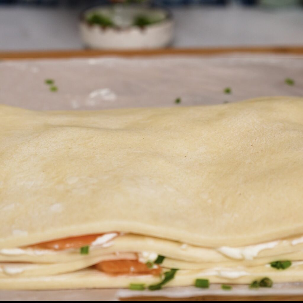 Layered puff pastry covered with the final pastry rectangle.