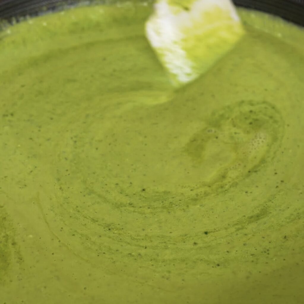 Creamy cottage cheese pesto sauce warming in a pan