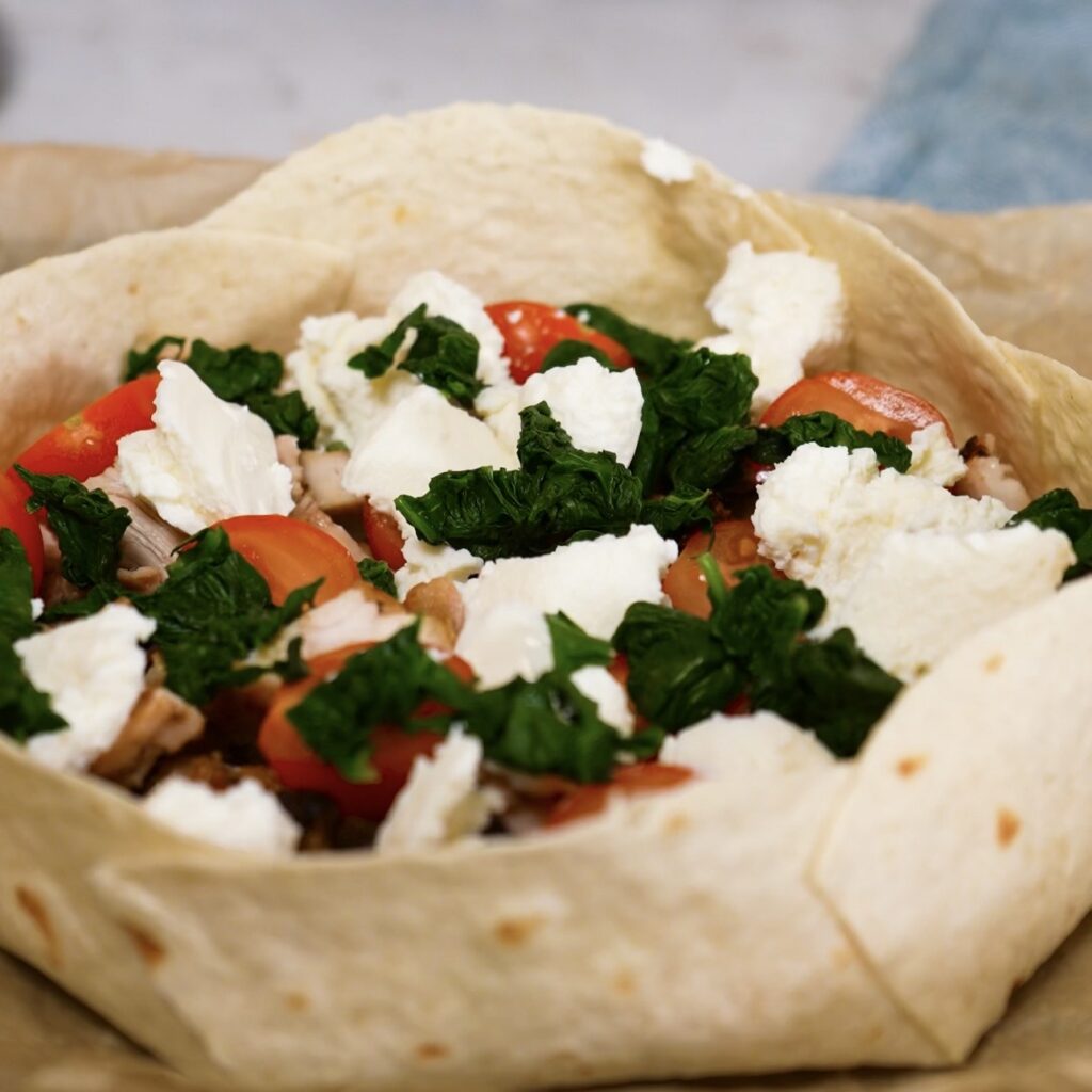 Chicken, ricotta, spinach and cherry tomatoes added to the tortilla bowl.