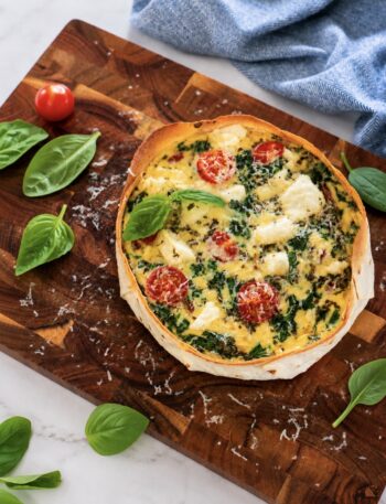 High-Protein Tortilla Chicken Quiche served on a wooden board.