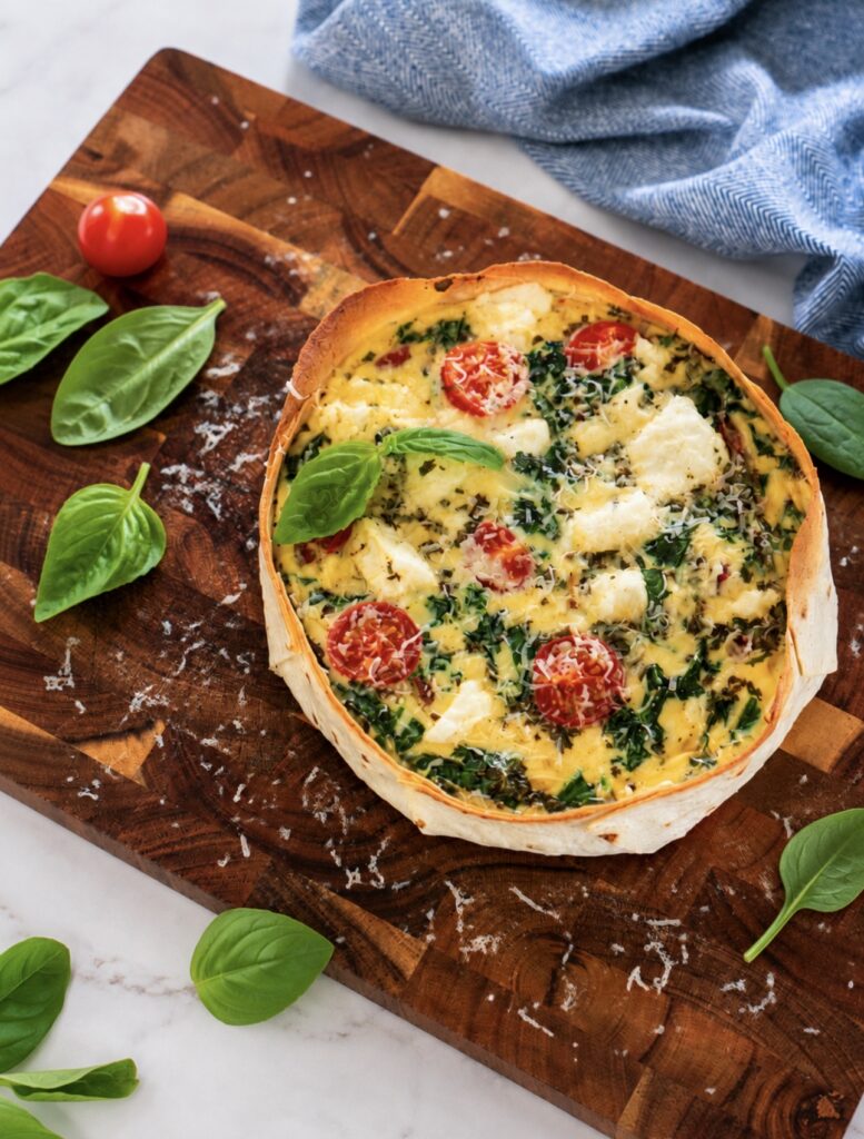 High-Protein Tortilla Chicken Quiche served on a wooden board.