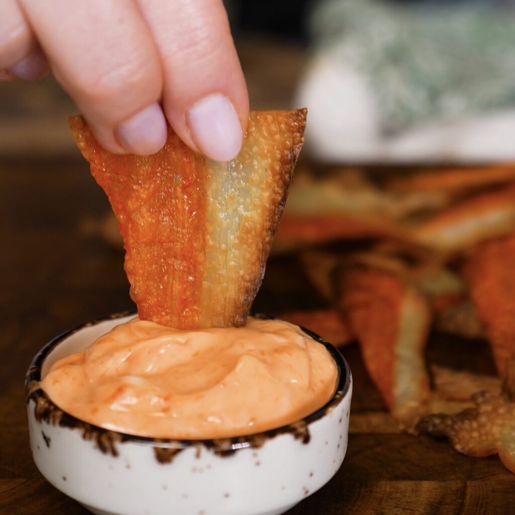 Crispy crab stick chip dipped into sriracha mayo sauce