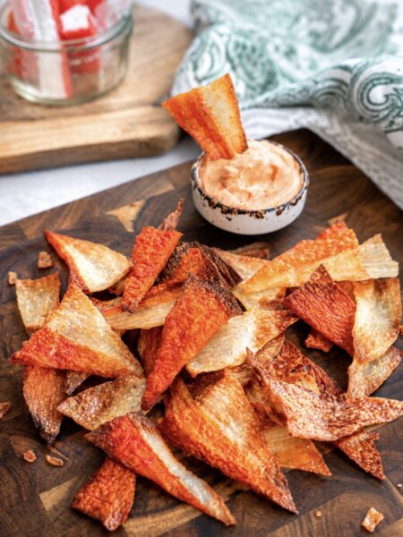 Crispy Air Fryer Crab Stick Chips served on a wooden board with sriracha mayo dip.