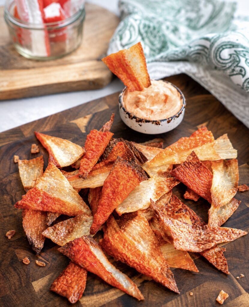 Crispy Air Fryer Crab Stick Chips served on a wooden board with sriracha mayo dip.