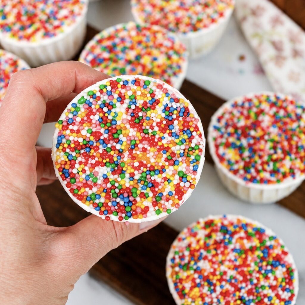 Hand holding a Banana Dot Cake.