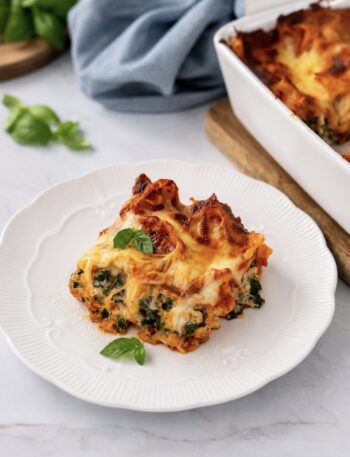 Piece of baked spinach and ricotta lasagna served on a plate