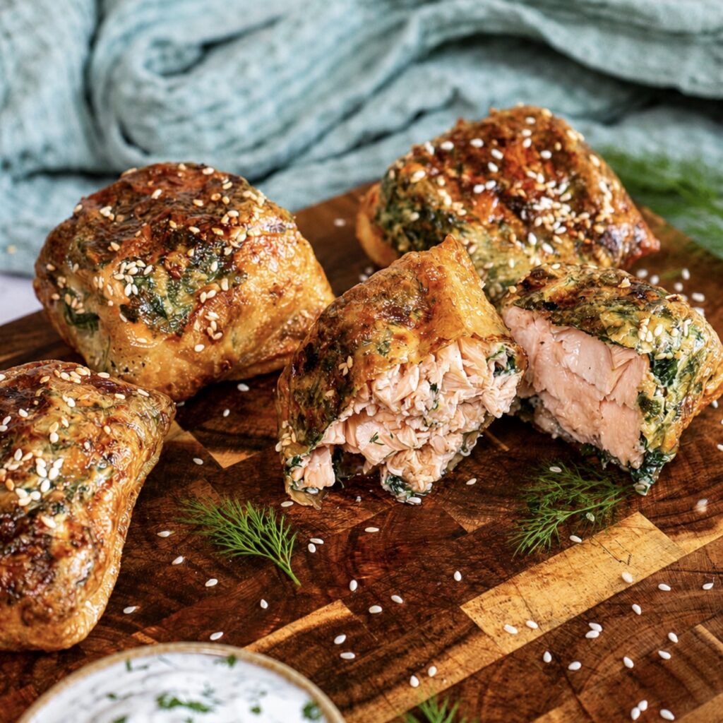 Rice paper salmon en croûte served on a wooden board.