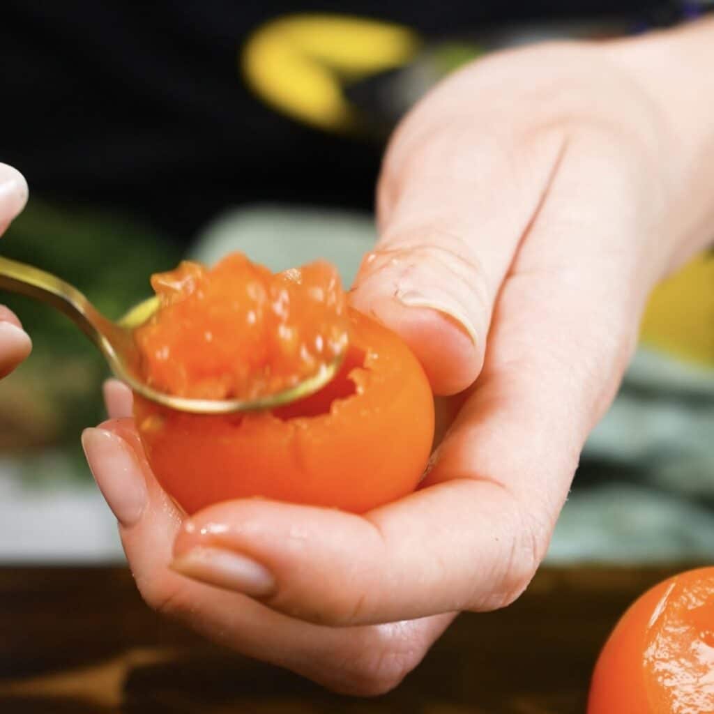 Hollowing out cocktail tomatoes for Baked Cottage Cheese Stuffed Tomatoes