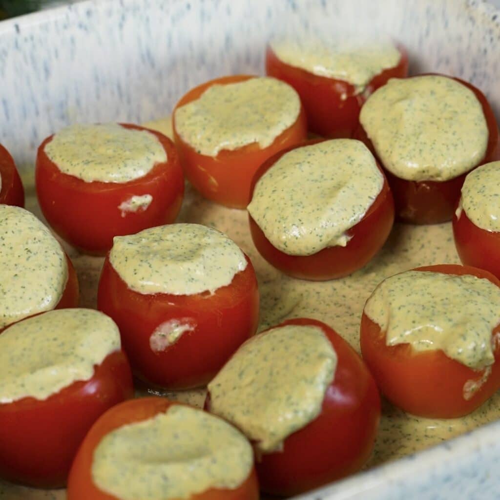 Stuffed tomatoes arranged in a baking dish before baking