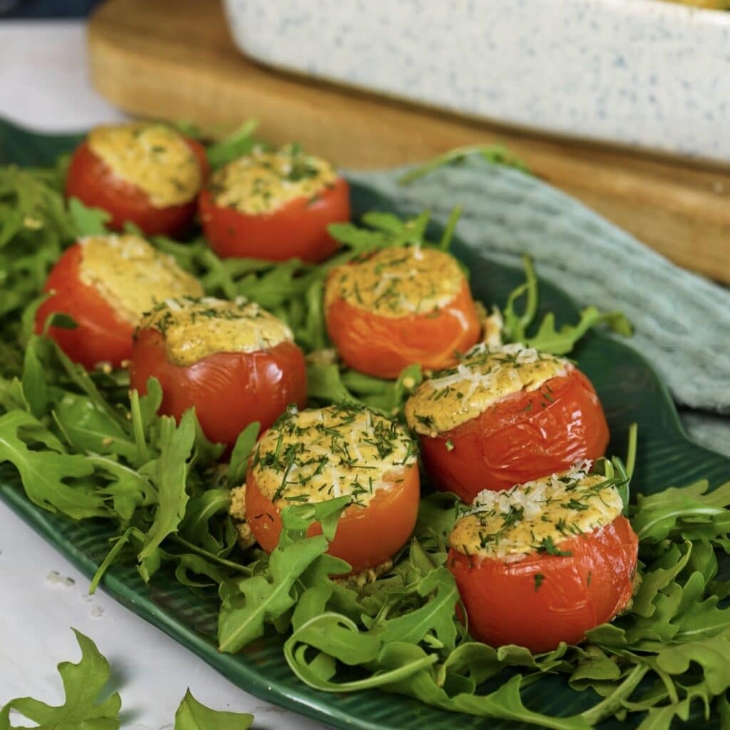 Baked cottage cheese stuffed tomatoes served on a plate