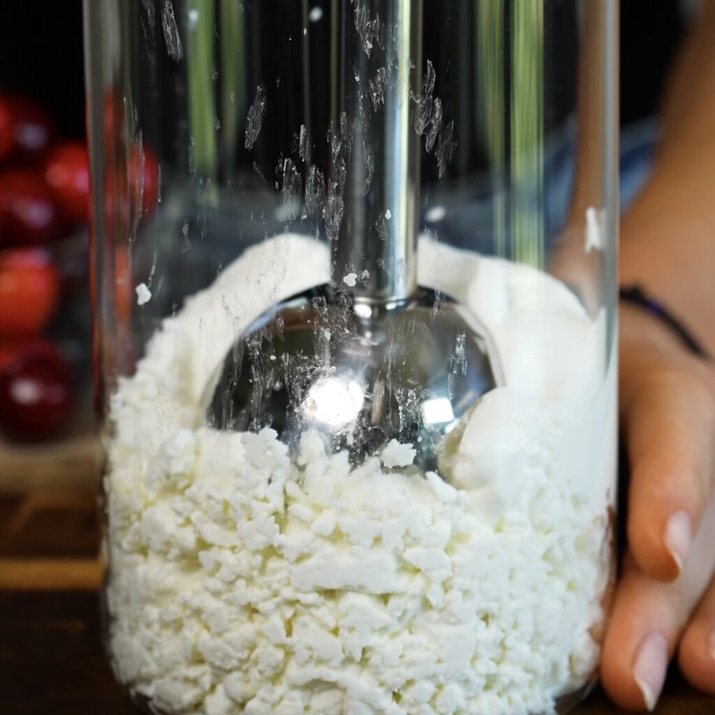 Cottage cheese, yoghurt, honey and vanilla being blended until smooth for the creamy bar filling.