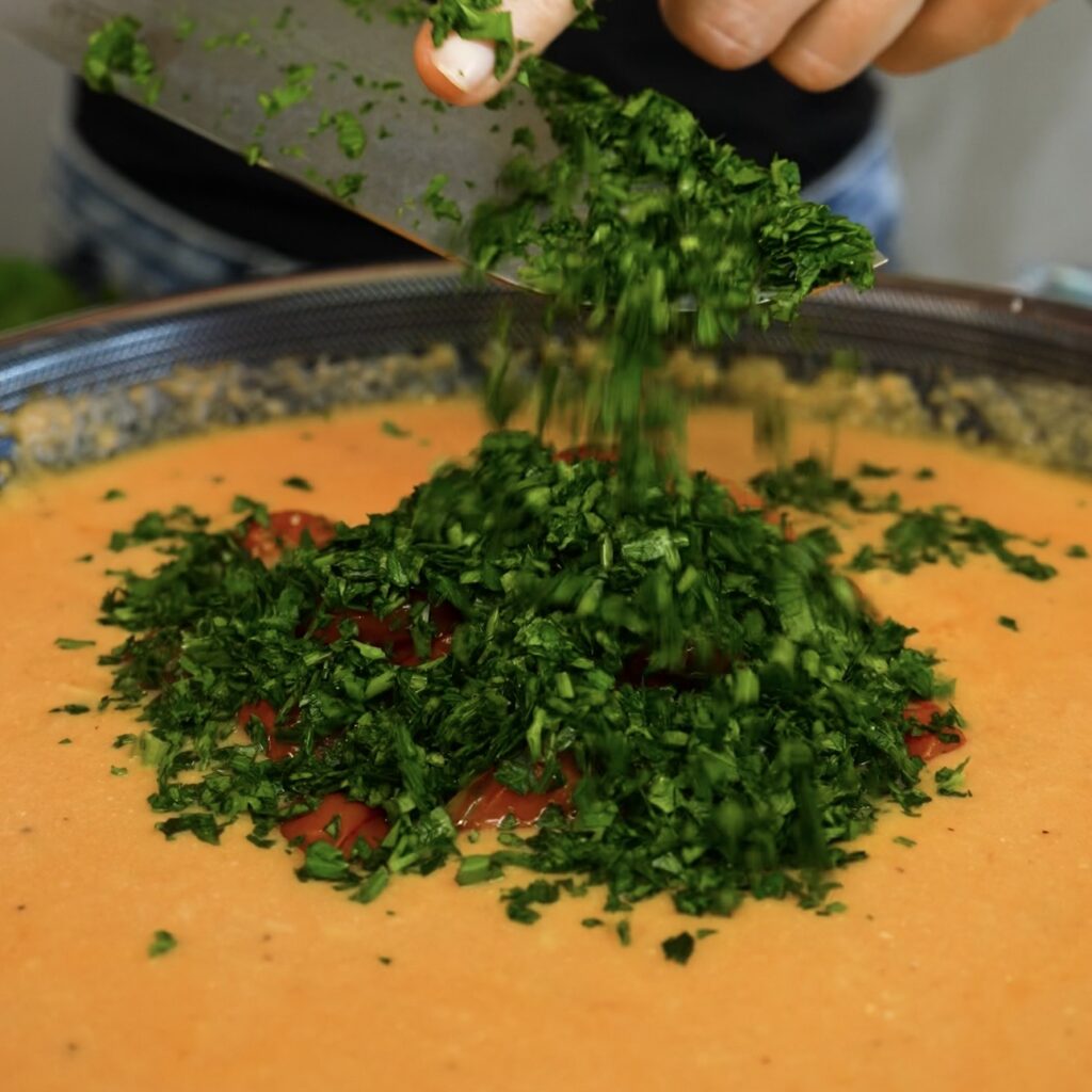 Reserved roasted cherry tomatoes and chopped parsley added to the roasted tomato and ricotta sauce.
