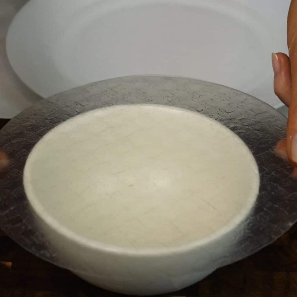 Briefly dipped rice paper placed over a small bowl for shaping