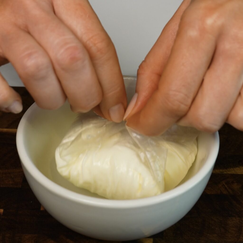 Sealing the softened rice paper around the cherry mochi filling