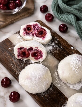 Cherry Rice Paper Mochi arranged on a wooden board with one sliced in half