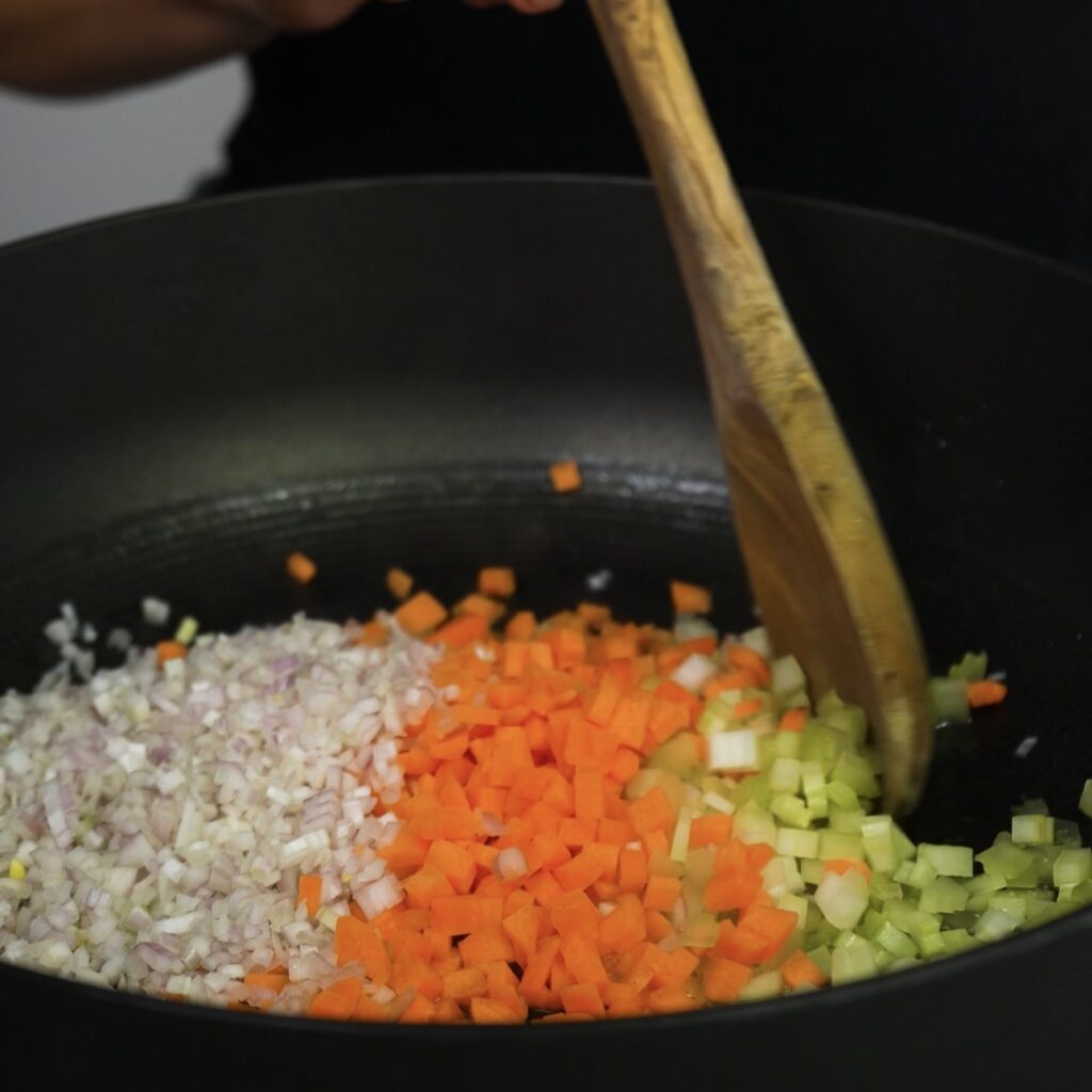 Cooking finely chopped onion, carrot and celery for the beef ragù