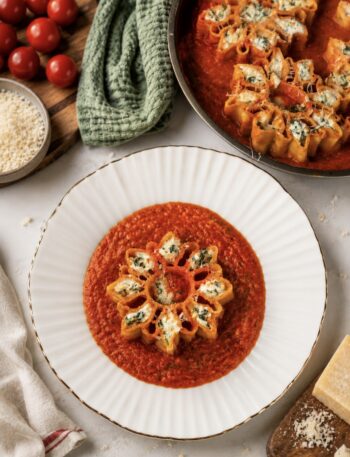 Roasted tomato four-cheese stuffed pasta served on a plate.