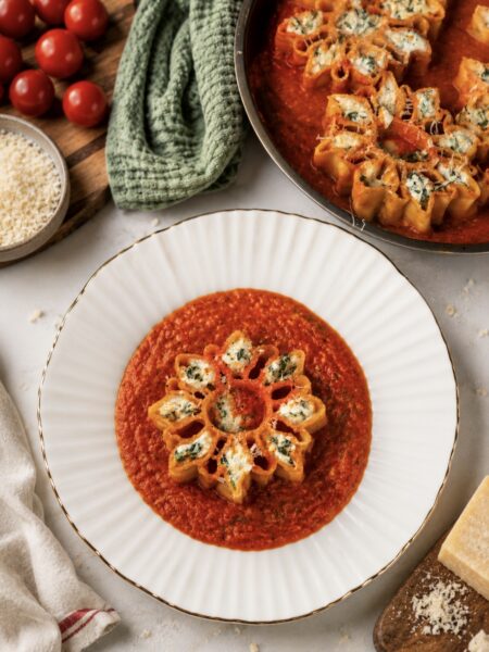 Roasted tomato four-cheese stuffed pasta served on a plate.