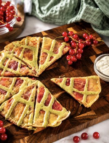 Redcurrant rice paper pancake cut into wedges and served on a wooden board