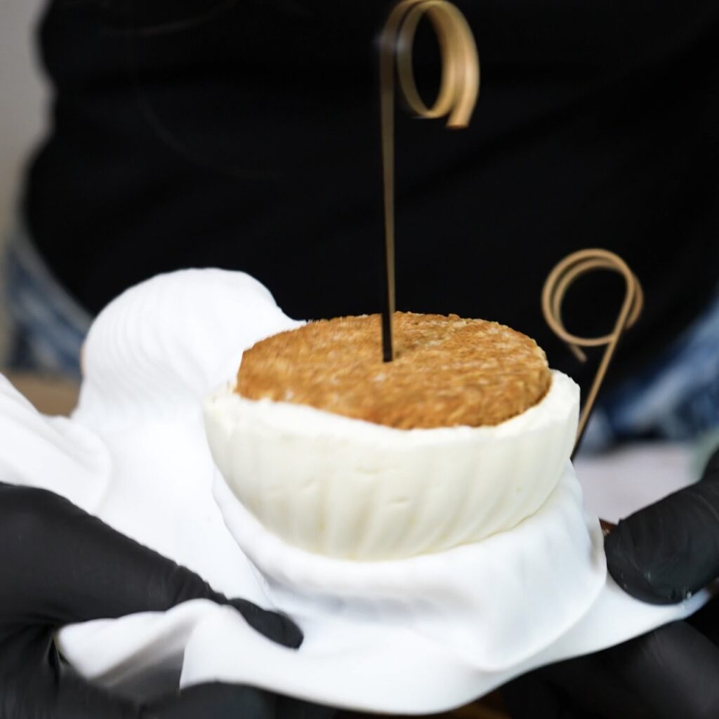 Frozen Blueberry Cottage Cheese Chocolate Spheres being removed from a silicone mould.