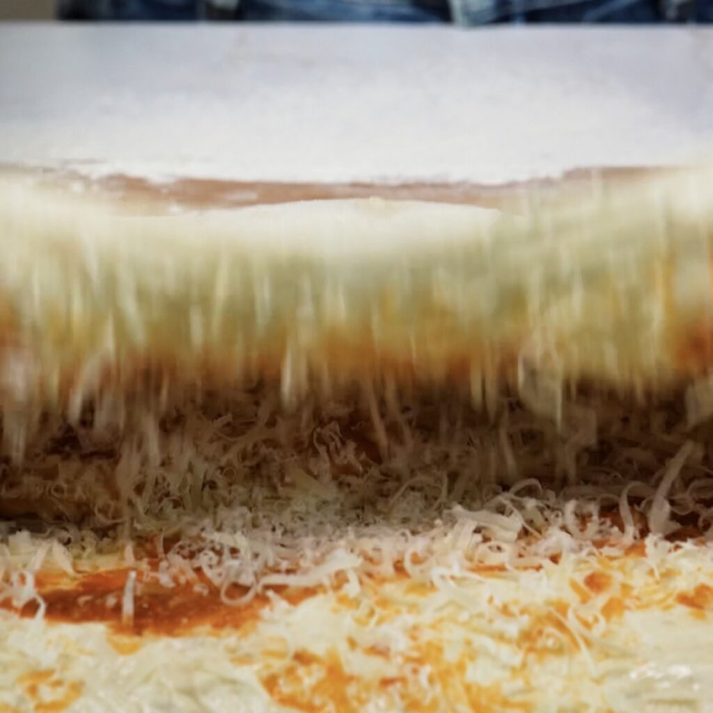 Bread dough folded in half over the sun-dried tomato pesto and Parmesan filling.