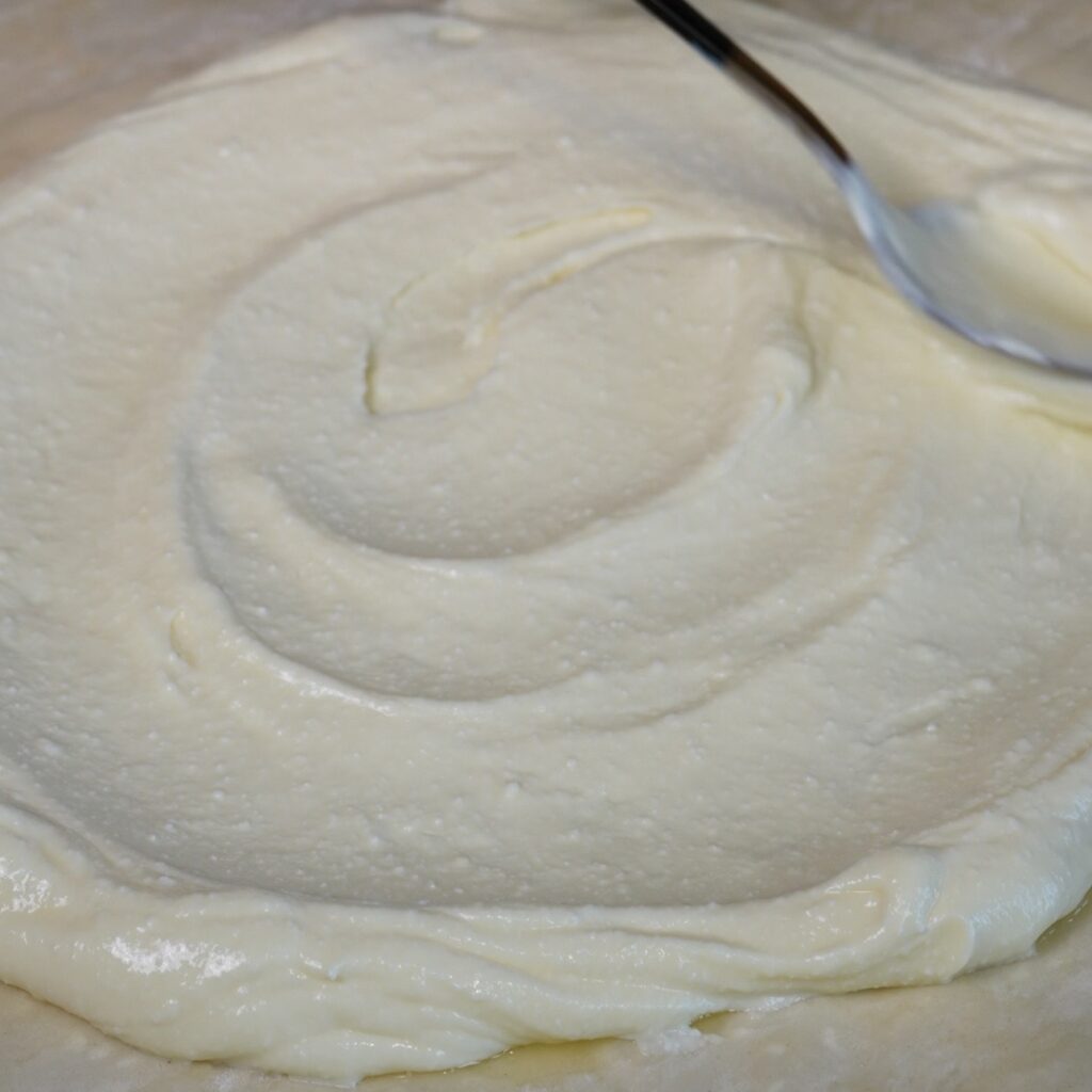 Spreading the creamy cottage cheese filling over the centre of the layered filo pastry for the Cottage Cheese Apricot Galette