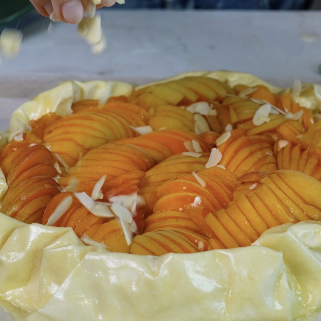 Sprinkling flaked almonds over the folded filo edges of the Cottage Cheese Apricot Galette