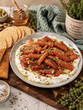 Whipped feta topped with honey-roasted baby carrots and crushed pistachios, served with toasted bread.