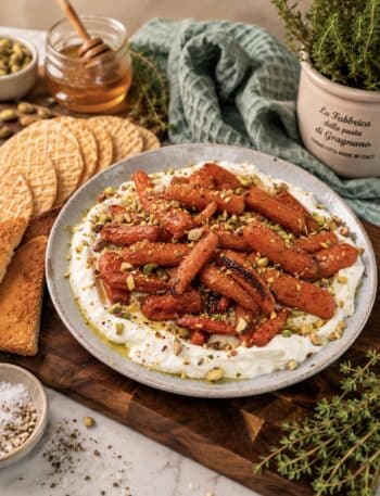 Whipped feta topped with honey-roasted baby carrots and crushed pistachios, served with toasted bread.