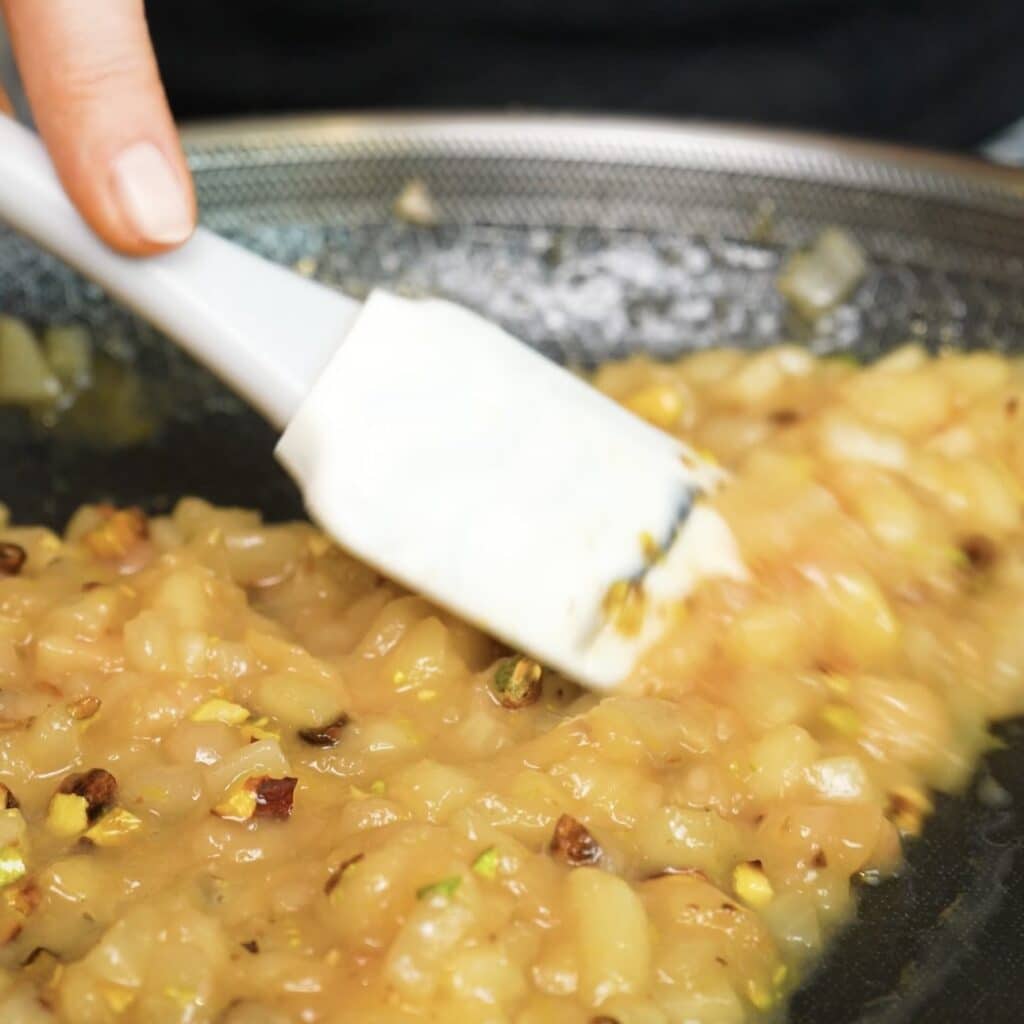 Cooking the peach filling with brown sugar, lemon zest and crushed pistachios for Sticky Peach and Pistachio Buns.