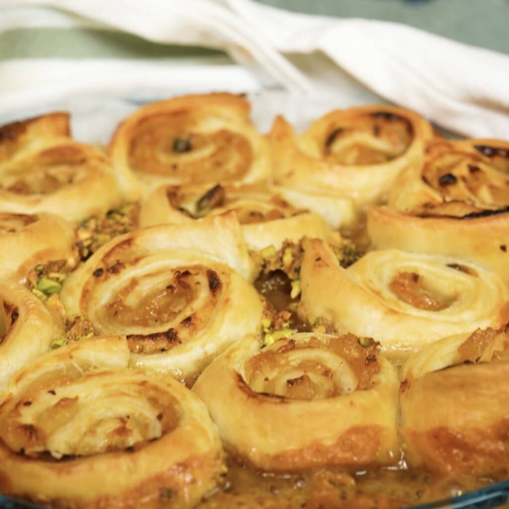 Freshly baked Sticky Peach and Pistachio Buns in the baking dish before being turned upside down.