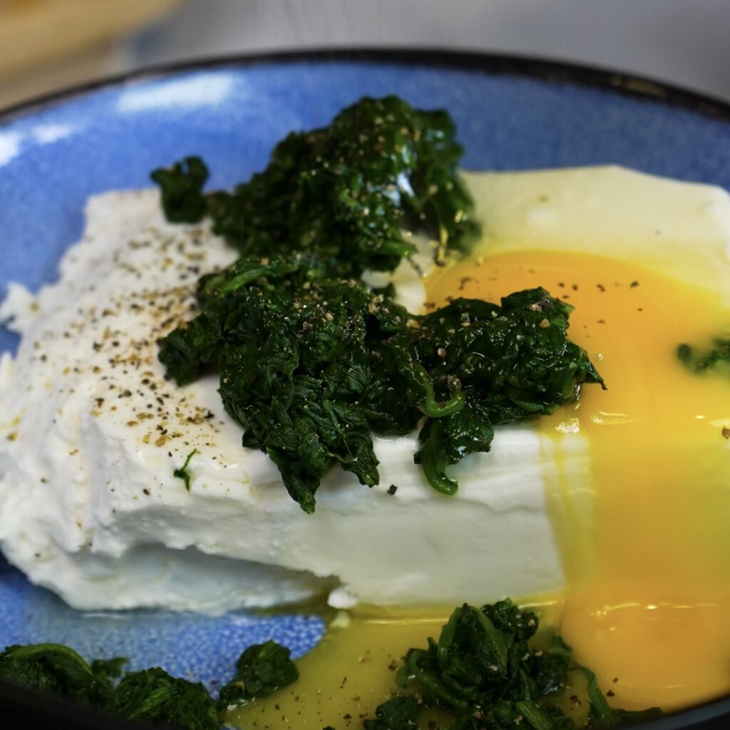 Feta, spinach, egg and black pepper in a bowl before mixing the filling
