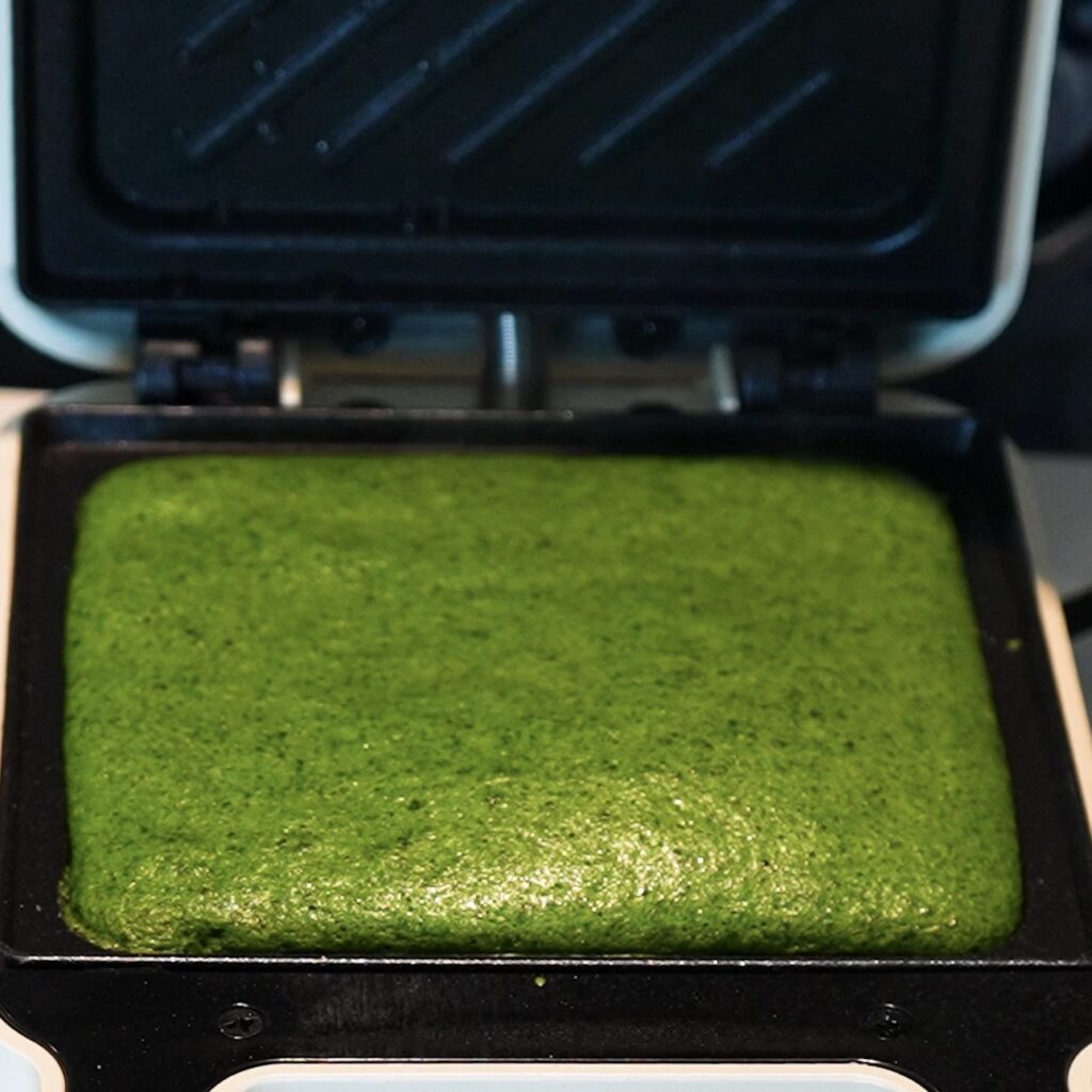 Cooked spinach bread in a sandwich maker