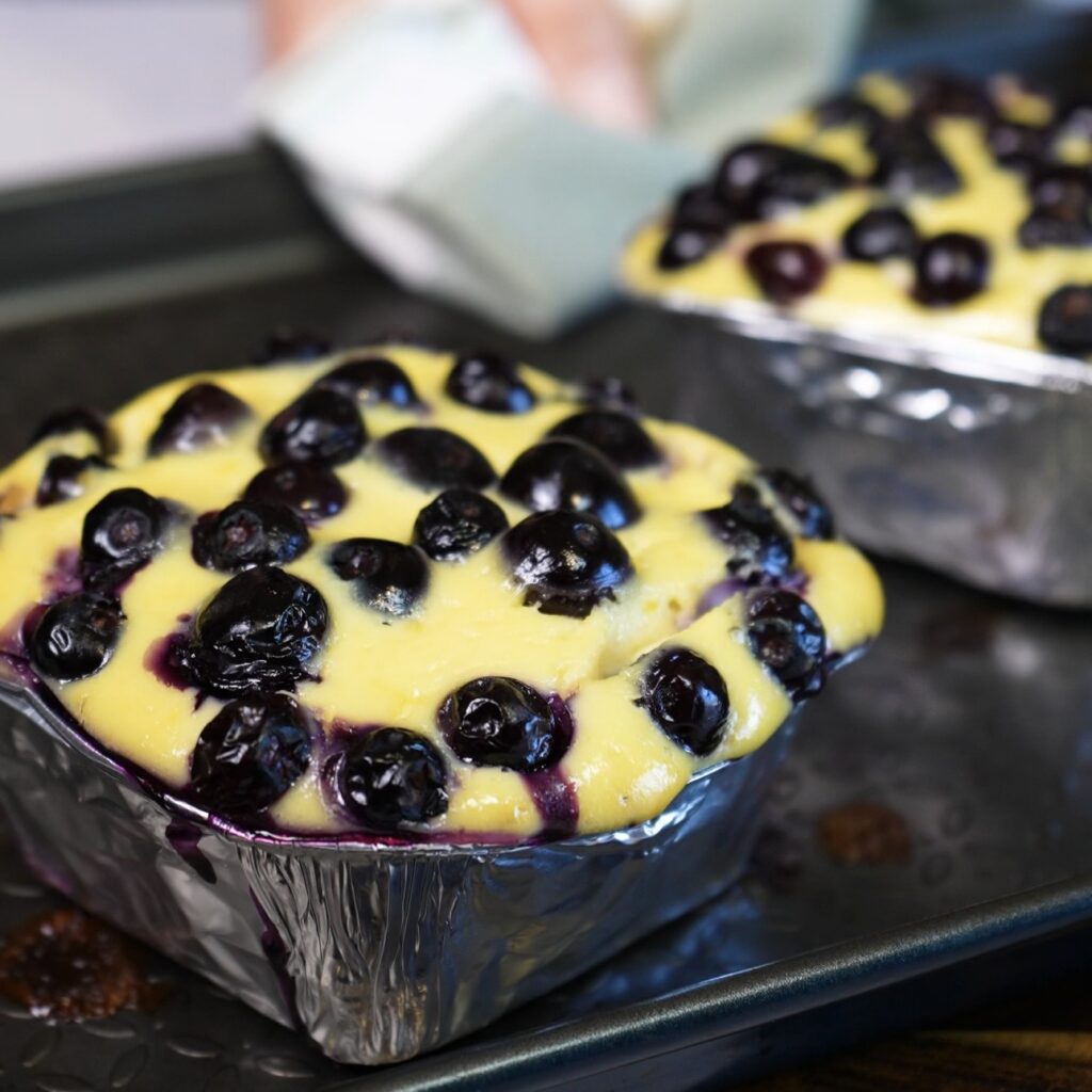 Freshly baked Blueberry Ricotta Lasagna straight from the oven with golden ricotta and juicy blueberries.