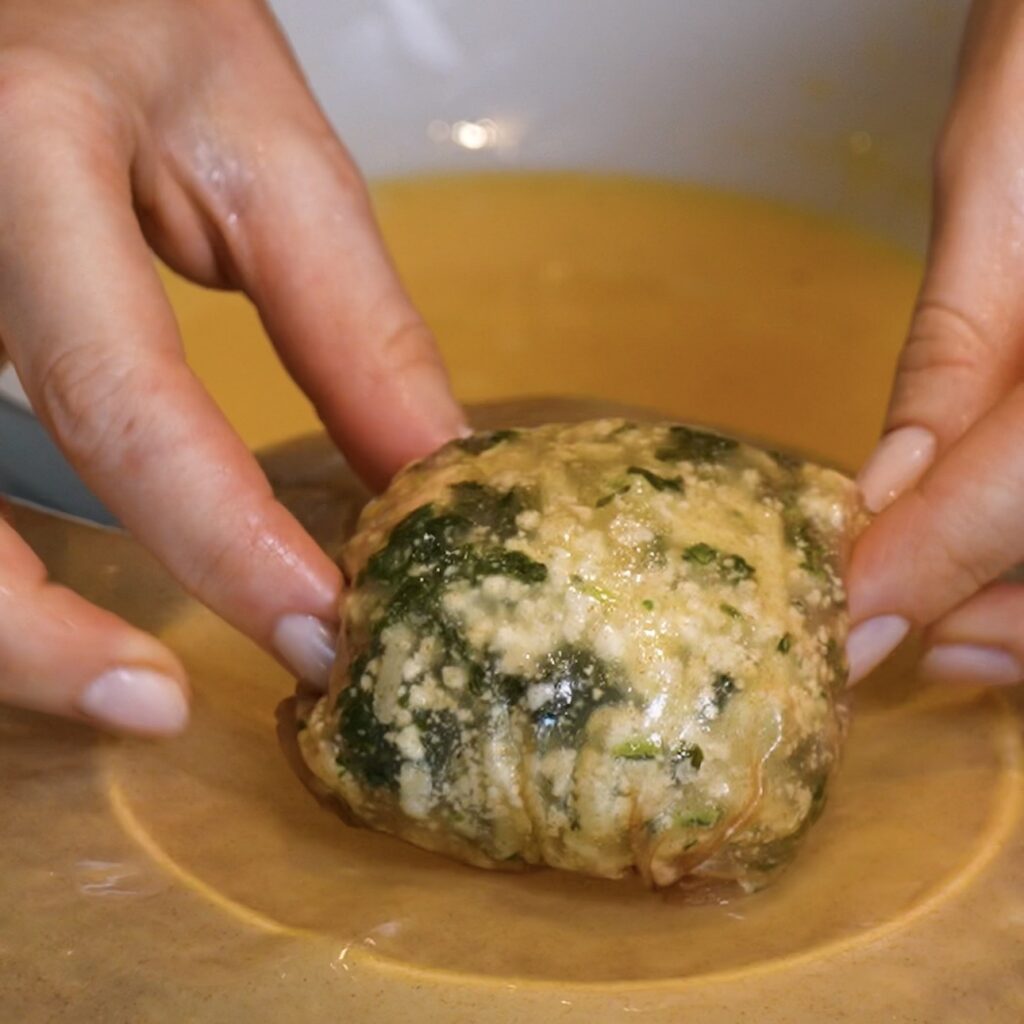 First rice paper bomb layer being placed onto a second softened rice paper sheet.
