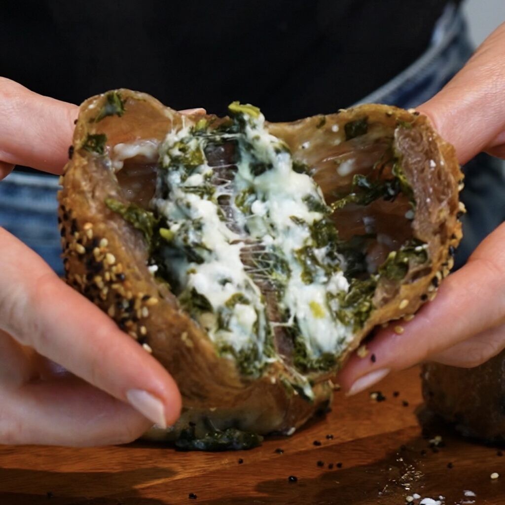 Spinach Feta Rice Paper Roll cut in half to reveal the spinach, feta and mozzarella filling.