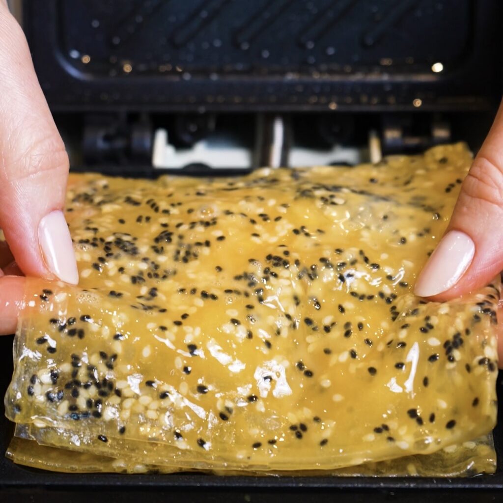 Final folded rice paper layer placed over the chicken, pesto and mozzarella filling.