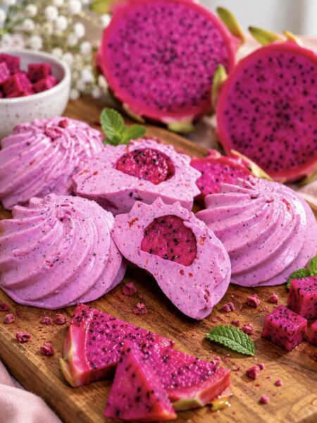 Fruity yogurt jellies served on a wooden board with one sliced in half