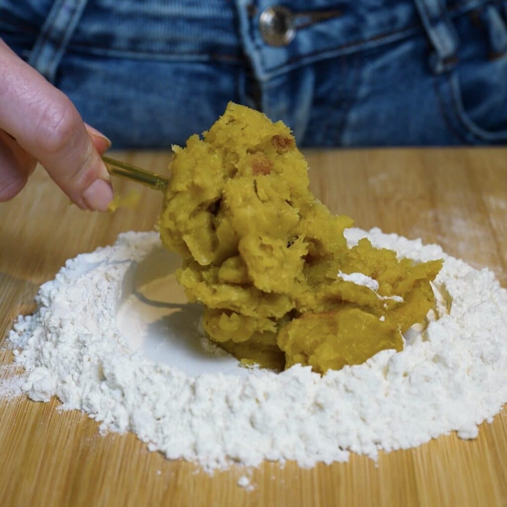 Adding blended Japanese sweet potato flesh to flour for homemade sweet potato gnocchi