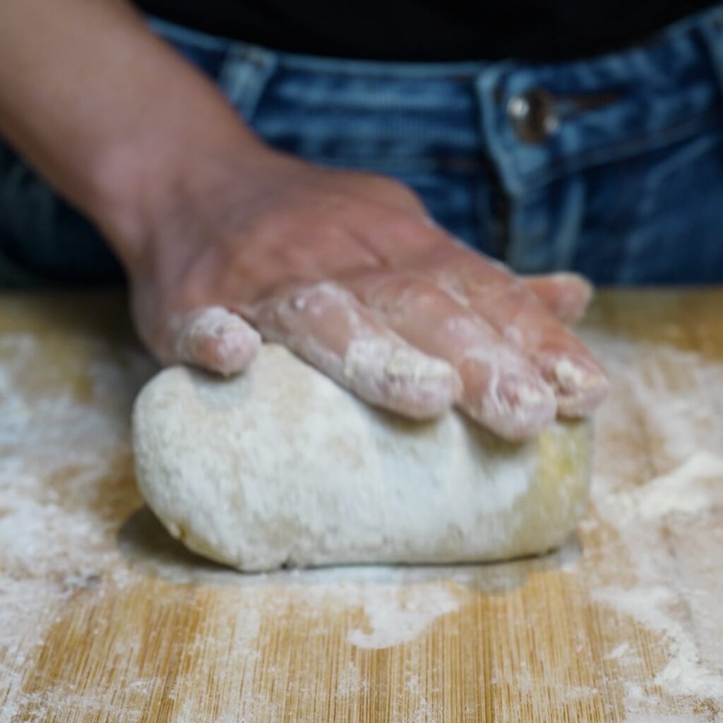 Lightly kneading sweet potato and flour until the gnocchi dough comes together
