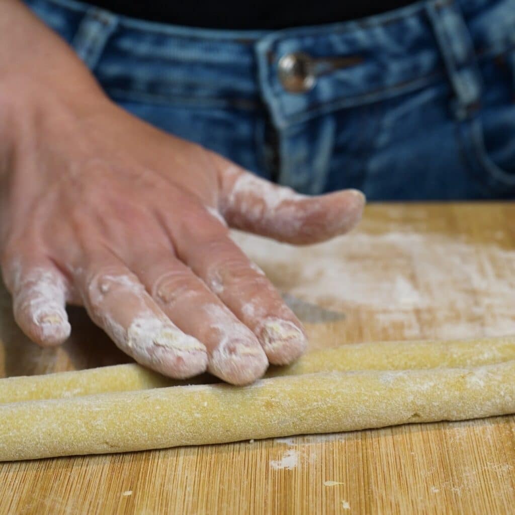 Rolling sweet potato gnocchi dough into two long ropes before cutting