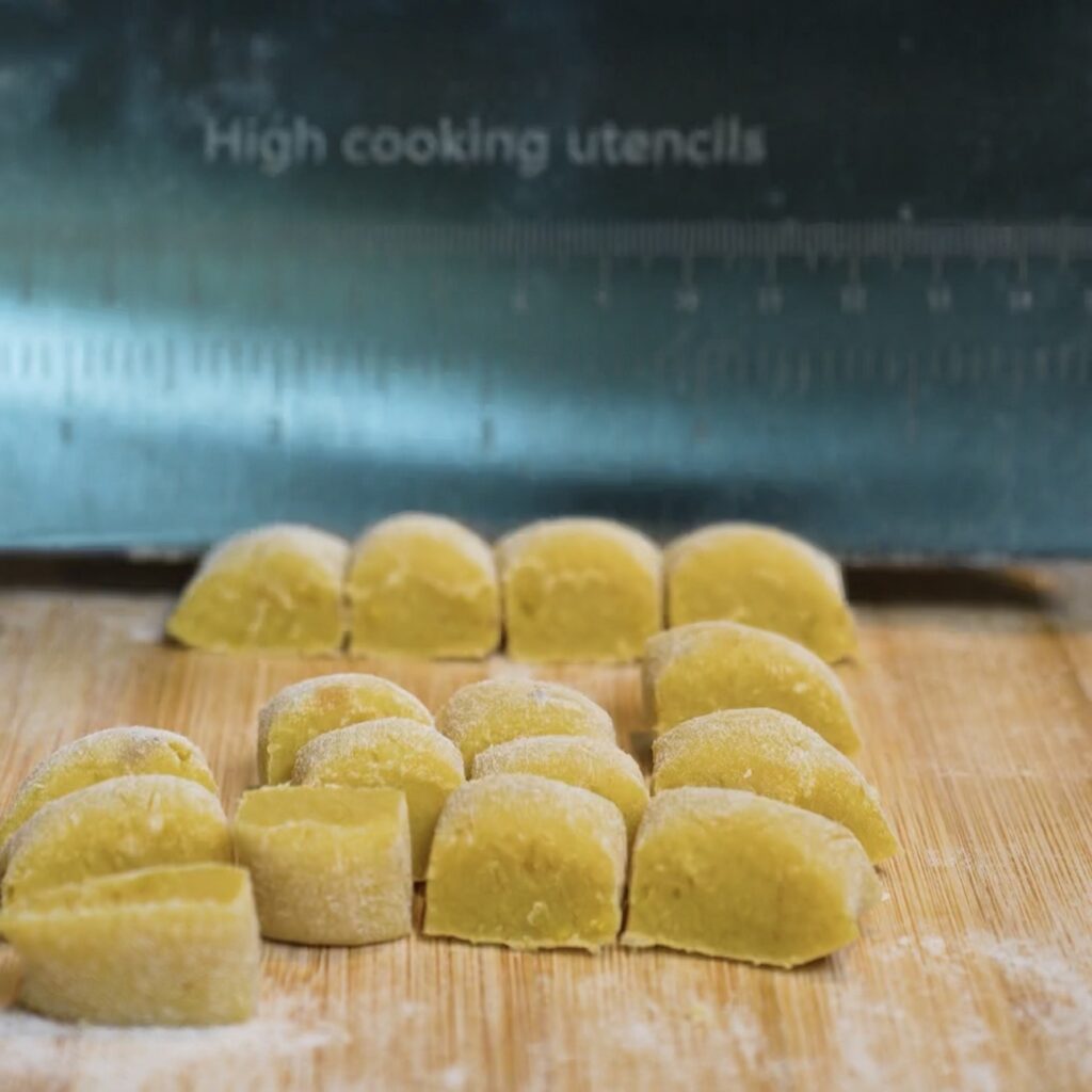 Cutting sweet potato gnocchi dough ropes into small even pieces