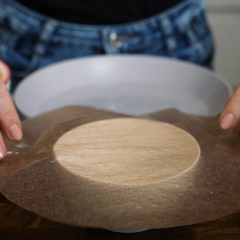 Briefly dipped rice paper placed over a small bowl ready to be shaped into mochi.